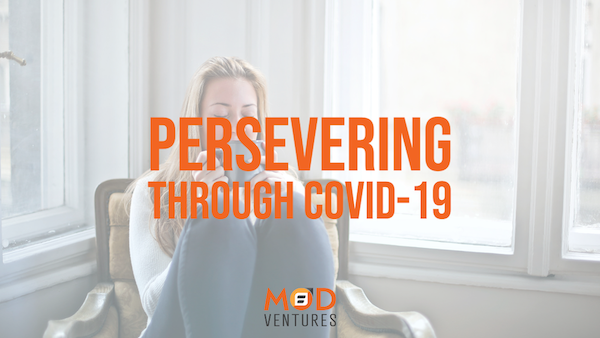 A woman sits on a chair by large windows; overlaid text reads "Persevering Through COVID-19" with the MOD Ventures LLC CPA logo below.